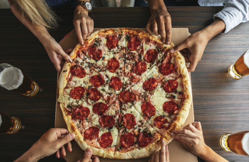 Pizza and pints of beer on a table